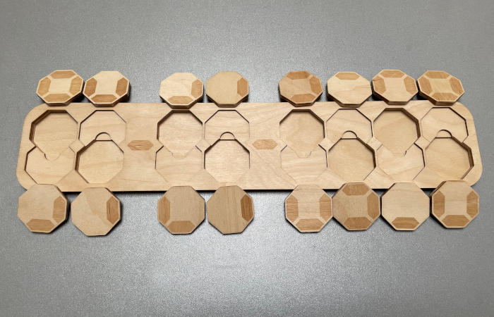 Photo of an empty board of calendar puzzle "Digital" with all 16 pieces around it